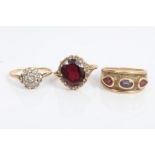 Three gold (9ct) and gem set dress rings - to include garnet single stone ring,