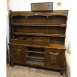 A 5' 6" 20th Century polished oak two part dresser with spindle galleried two shelf open plate