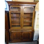 A 4' 8" early Victorian mahogany book cabinet with moulded cornice, flanking acanthus capitals,