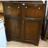 A 3' 8" early 20th Century stained walnut and mixed wood gentleman's compactum wardrobe "The