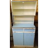 A 32 1/2" 1950's painted wood and blue formica kitchen unit with sliding glass doors to top, shelf