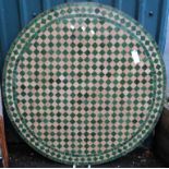 A 3' 4" diameter Spanish circular concrete exterior table top with checkerboard tile decoration