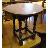 A circular oak occasional table, set on turned supports