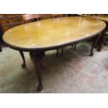 A 6' early 20th Century mahogany oval dining table, set on heavy cabriole legs with pad feet and