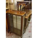 A nest of three polished wood tea tables with glass inset tops, set on slender cabriole legs with