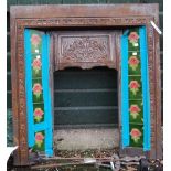 An early 20th Century cast iron fire surround set with decorative tube-lined floral tiles - sold