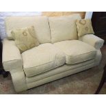 A 5' 6" modern two seater settee upholstered in beige patterned material