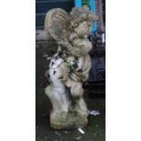 A 28" pre-cast garden statue of a putto playing a tambourine