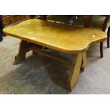 A 3' 3" varnished elm rustic coffee table, set on shaped standard ends with pegged stretcher