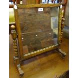 An early 20th Century oak dressing table mirror, set on bobbin turned supports