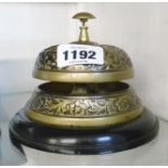 A reproduction brass reception bell