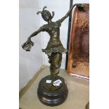 A 15" bronzed figure of a dancing girl, set on a socle base