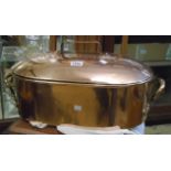 A 20" antique copper oval lidded fish kettle with heavy brass carrying handles