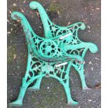 A pair of painted cast iron bench ends with pierced decoration