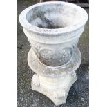 A 14" diameter concrete garden planter with floral scroll decoration, set on an ornate pedestal base