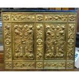 An Edwardian pigskin document holder with heavily embossed brass front panel