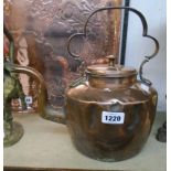 A Georgian copper kettle with scroll handle