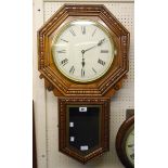 An American stained and polished oak cased drop-dial wall clock with brass bezel, 12" dial and