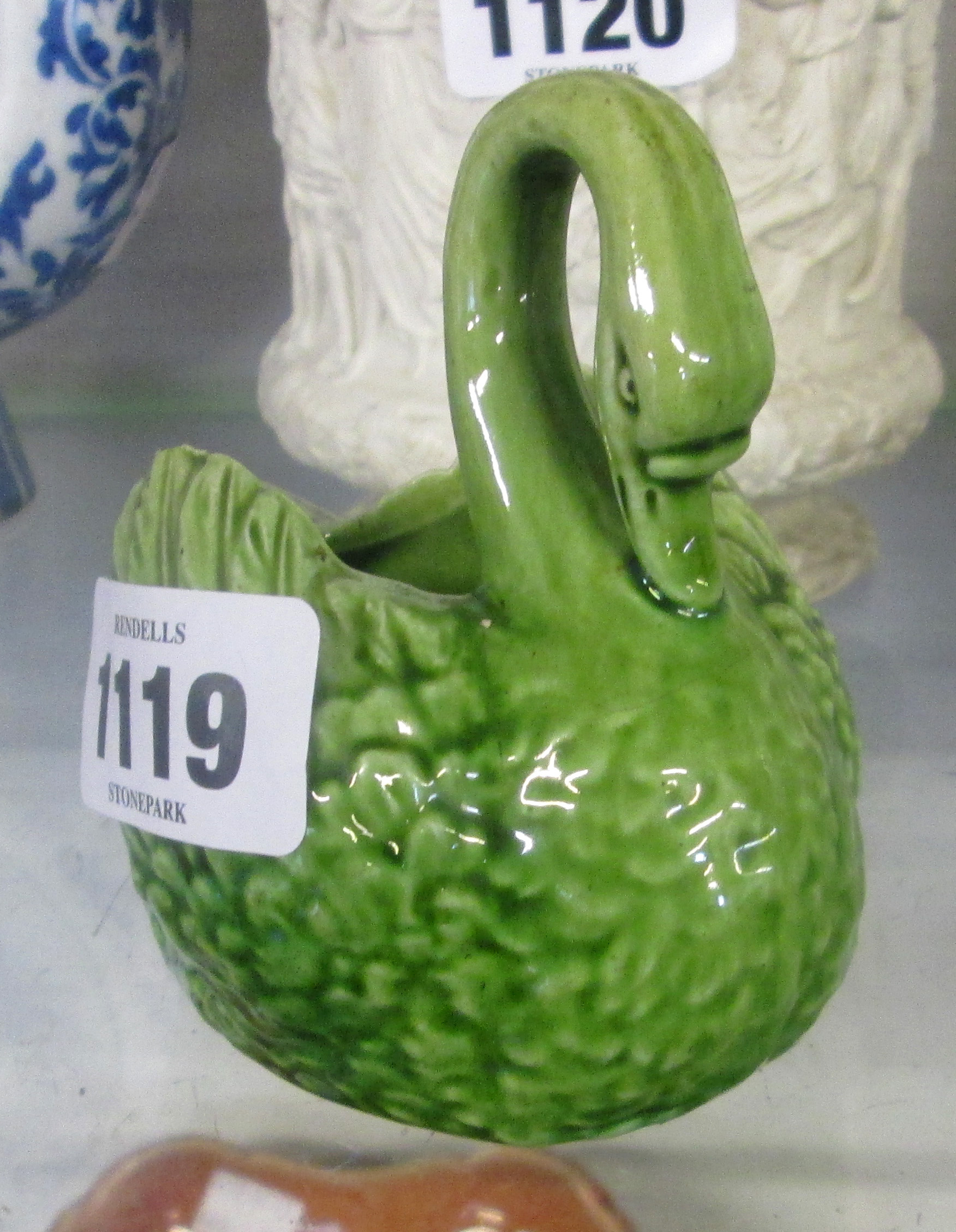 A 4" Watcombe green glazed pottery swan - minor chip to wing