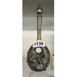 An 8" green lustre glass scent bottle with pierced body and applied silvered floral decoration