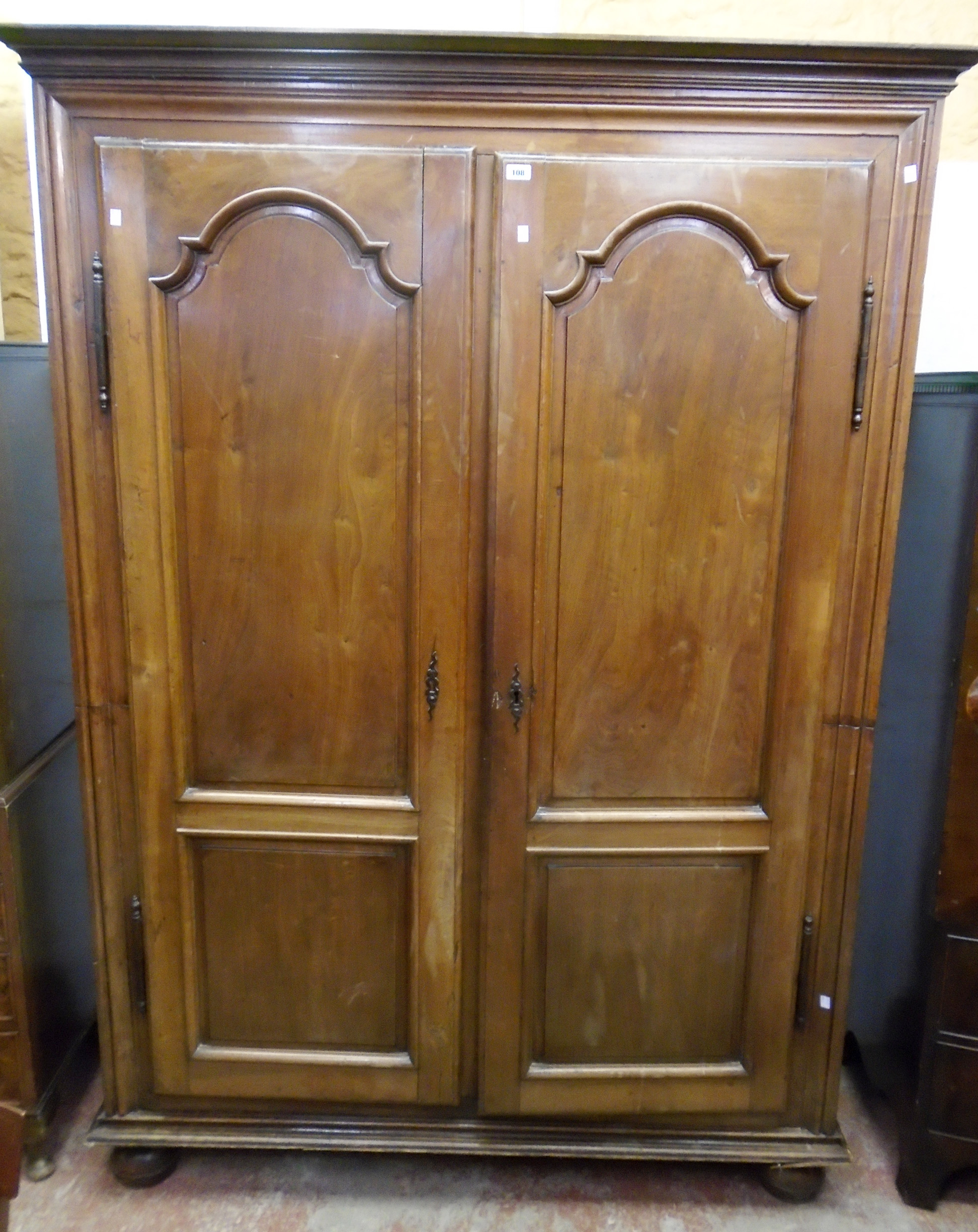 A 5' 19th Century French walnut armoire with moulded cornice and part fitted interior enclosed by