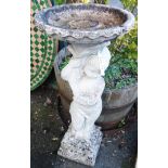 A 35" concrete two part birdbath in the form of a putto holding a cornucopia