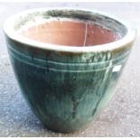 A 21 1/2" diameter green/blue glazed terracotta planter