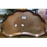 An Art Nouveau style hammered copper kidney shaped tray with frilled rim and etched floral