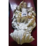 A ceramic wall pocket with cherub, text and religious imagery