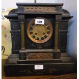 A late Victorian black slate cased mantel clock of architectural design with black and gilt dial,