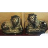 A pair of 9 1/2" high Bo'ness pottery recumbent grey lions with glass eyes and gilt highlighting -