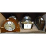 Three mid 20th Century oak cased eight day striking mantel clocks, a Smiths mantel timepiece and a