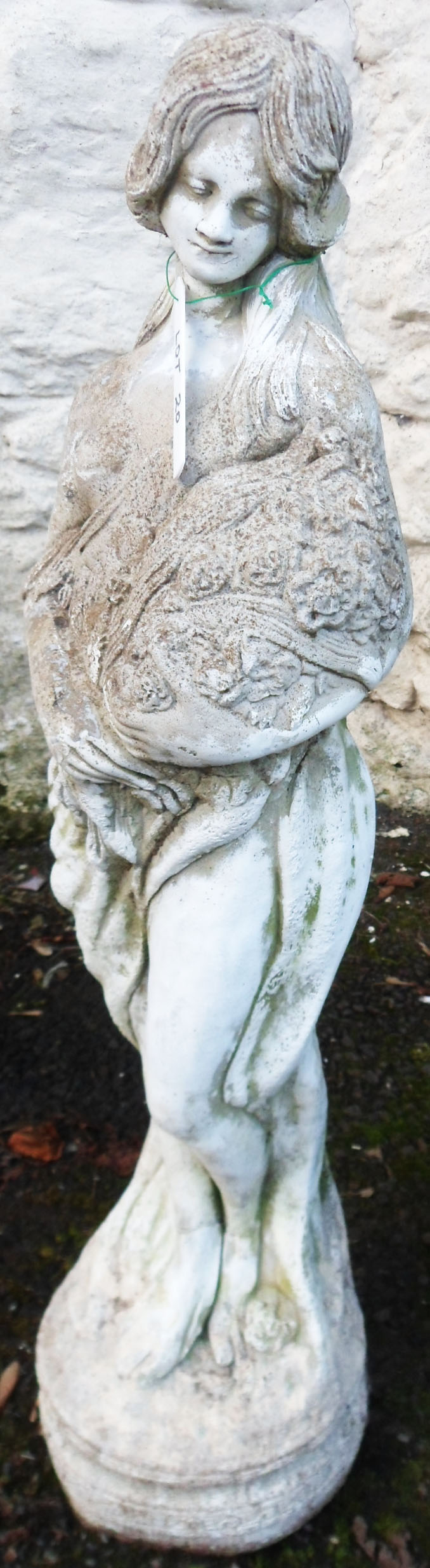 A 32" concrete garden statue in the form of a classical maiden carrying a bouquet of flowers