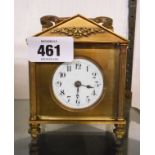 A brass and bevelled glass cased carriage timepiece of architectural design with carrying handle,