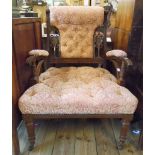 An Edwardian walnut framed salon open armchair with button back upholstery and flanking pierced vase