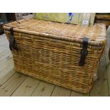 A 30" vintage wicker laundry basket with flanking carrying handles