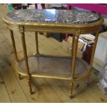 A 33" continental giltwood centre table with grey and white marble oval inset top and rattan
