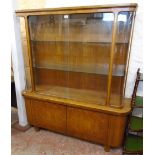 A 4' 10" German retro walnut veneered and mixed wood two part bow front display cabinet with