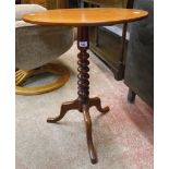 A Victorian mahogany pedestal wine table with oval tilt-top, set on bobbin turned pillar and