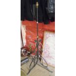 A wrought iron adjustable standard lamp