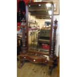A 3' 6" Victorian stained oak ornate cheval mirror with pierced scroll pediment to arched plate, set