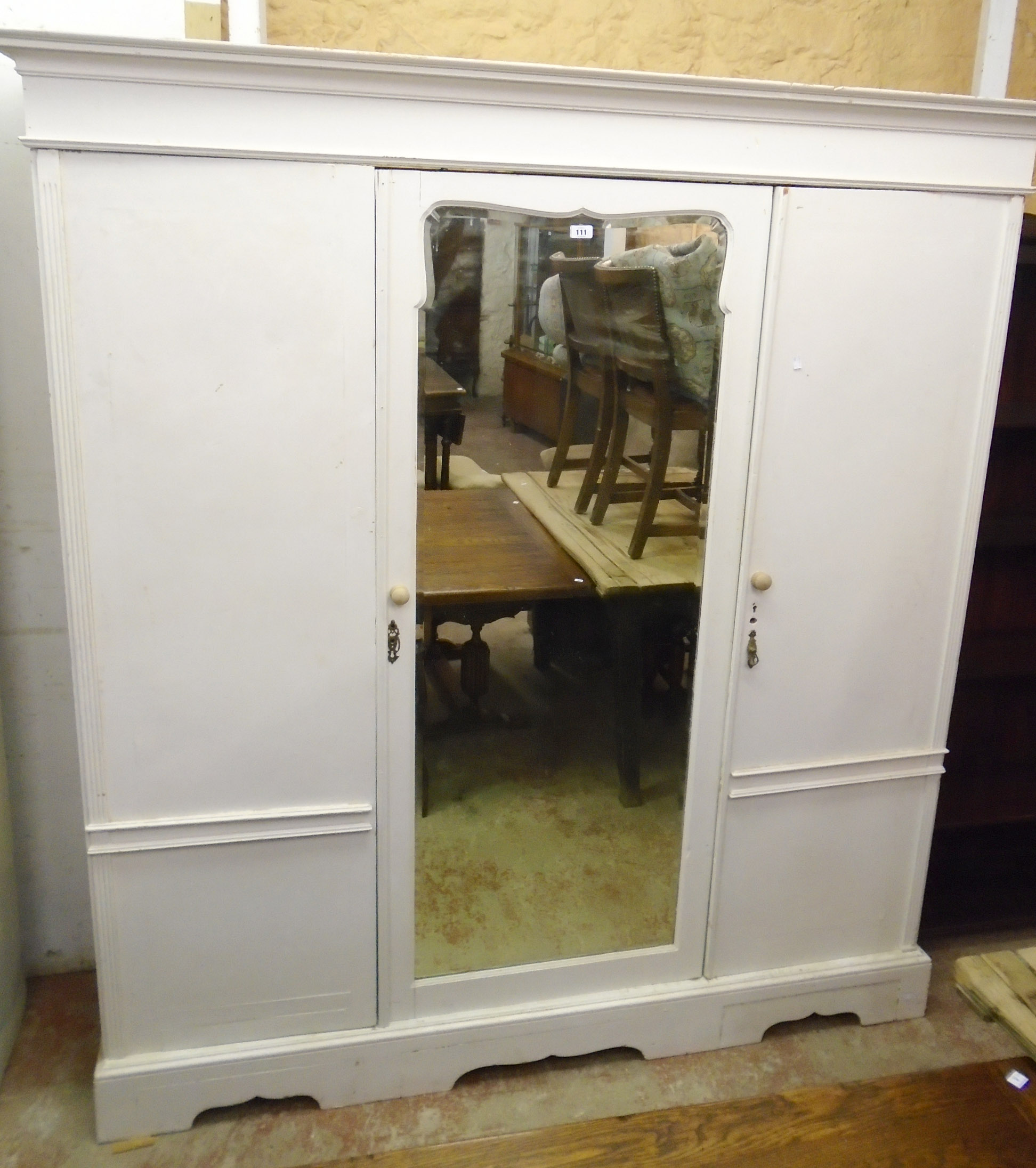 A 6' 3" Victorian triple wardrobe with central shaped mirror panel door and flanking cupboard