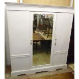 A 6' 3" Victorian triple wardrobe with central shaped mirror panel door and flanking cupboard