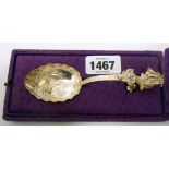 A boxed ornate Dutch silver spoon with scroll terminal, cast ship motif and curved handle, the