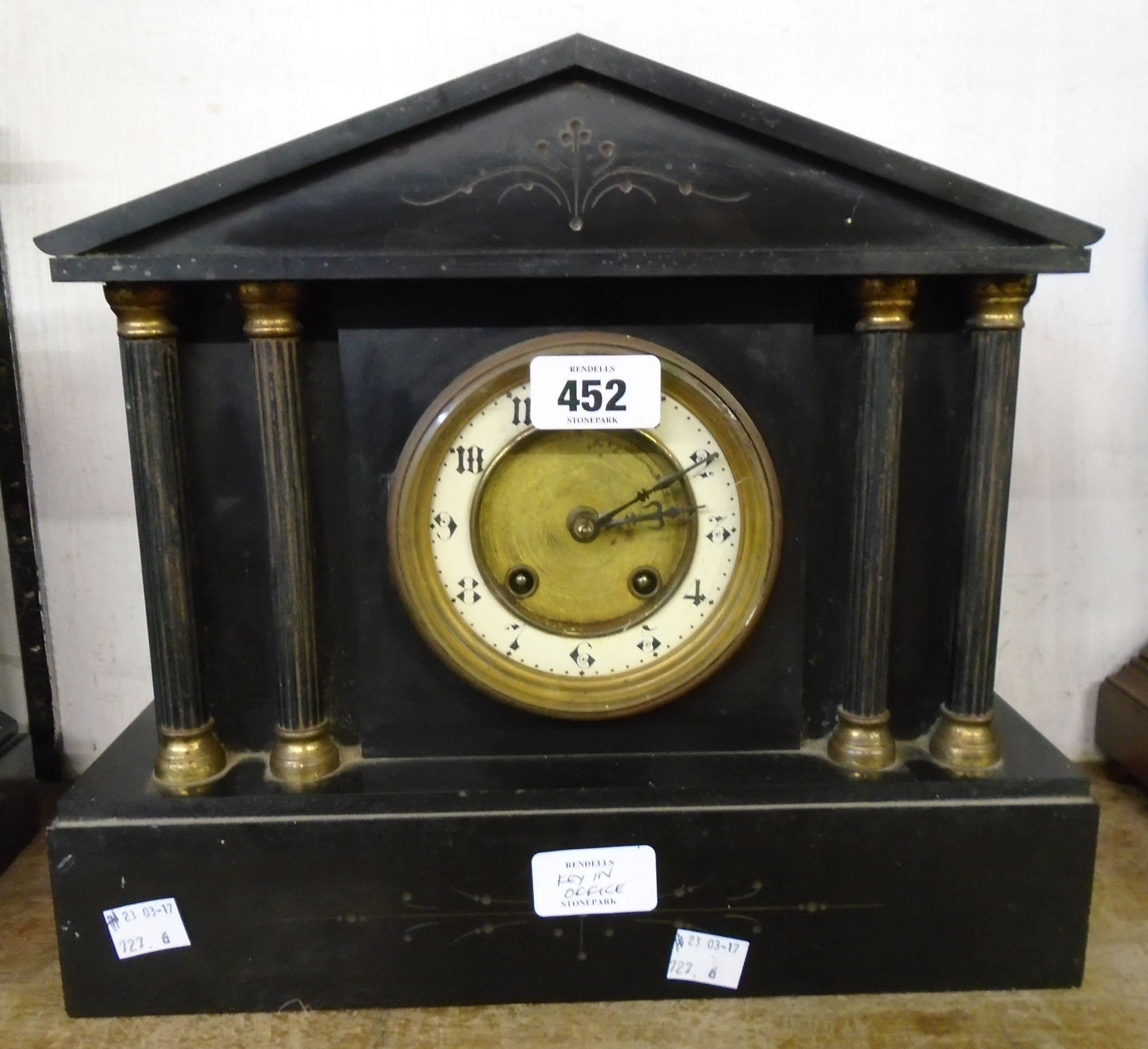 A late Victorian black slate cased mantel clock of architectural design with twin flanking columns