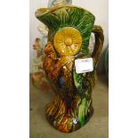 An 8 1/4" coloured treacle glazed pottery owl pattern jug - minor chip to spout