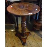 An 18" diameter mahogany pedestal table, set on heavy turned pillar and trefoil base with bun feet