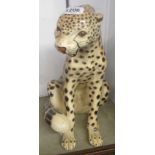 A 15" high ceramic figurine of a seated leopard