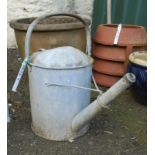A vintage galvanised 1 1/2 gallon watering can