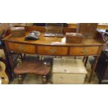 A 5' early 19th Century mahogany bow front sideboard with raised gallery back and sides and three